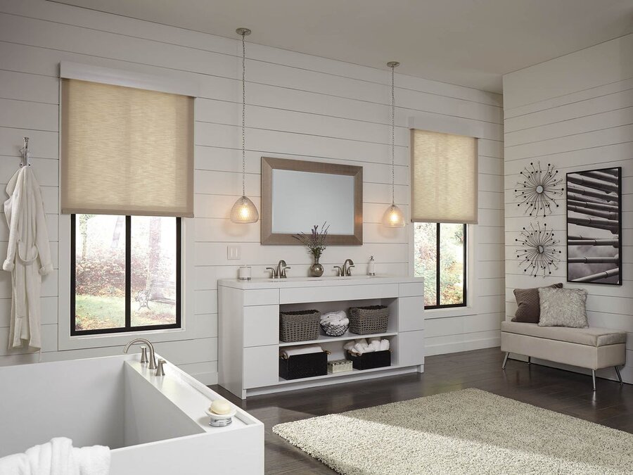 A bathroom with two windows featuring Lutron motorized shades lowered halfway.