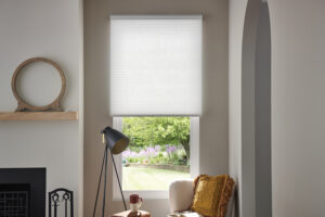 A home interior with Lutron cellular shades lowered halfway on a window.
